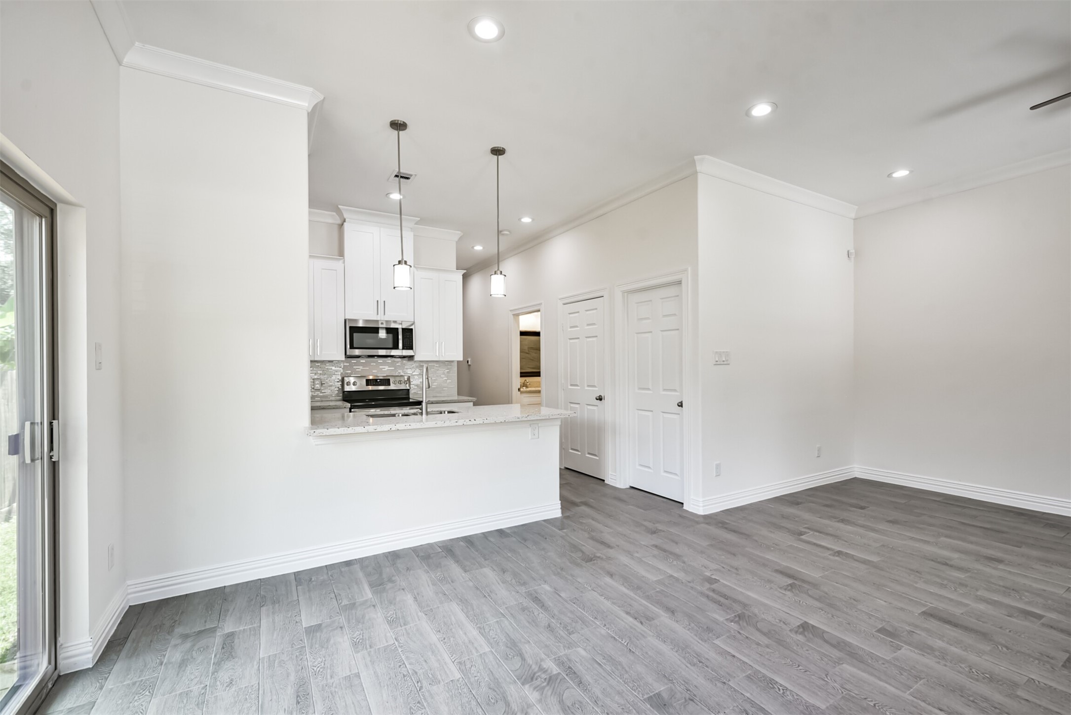 5114 Higgins Street, Unit A Houston, TX 77033 - Photo 28 of 28 a large white kitchen with a refrigerator a stove top oven a sink and a window