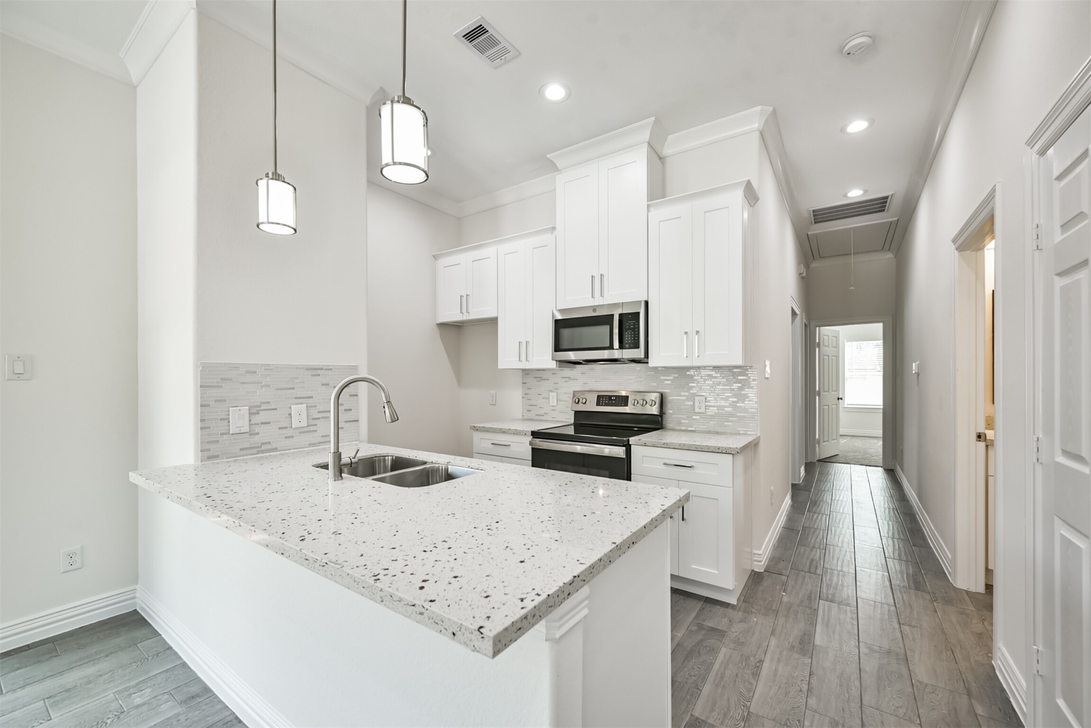 5114 Higgins Street, Unit A Houston, TX 77033 - Photo 9 of 28 a kitchen with stainless steel appliances kitchen island granite countertop a sink a stove and a wooden floors