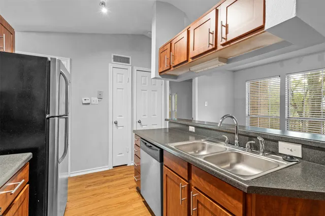 a kitchen with stainless steel appliances granite countertop a stove microwave and refrigerator