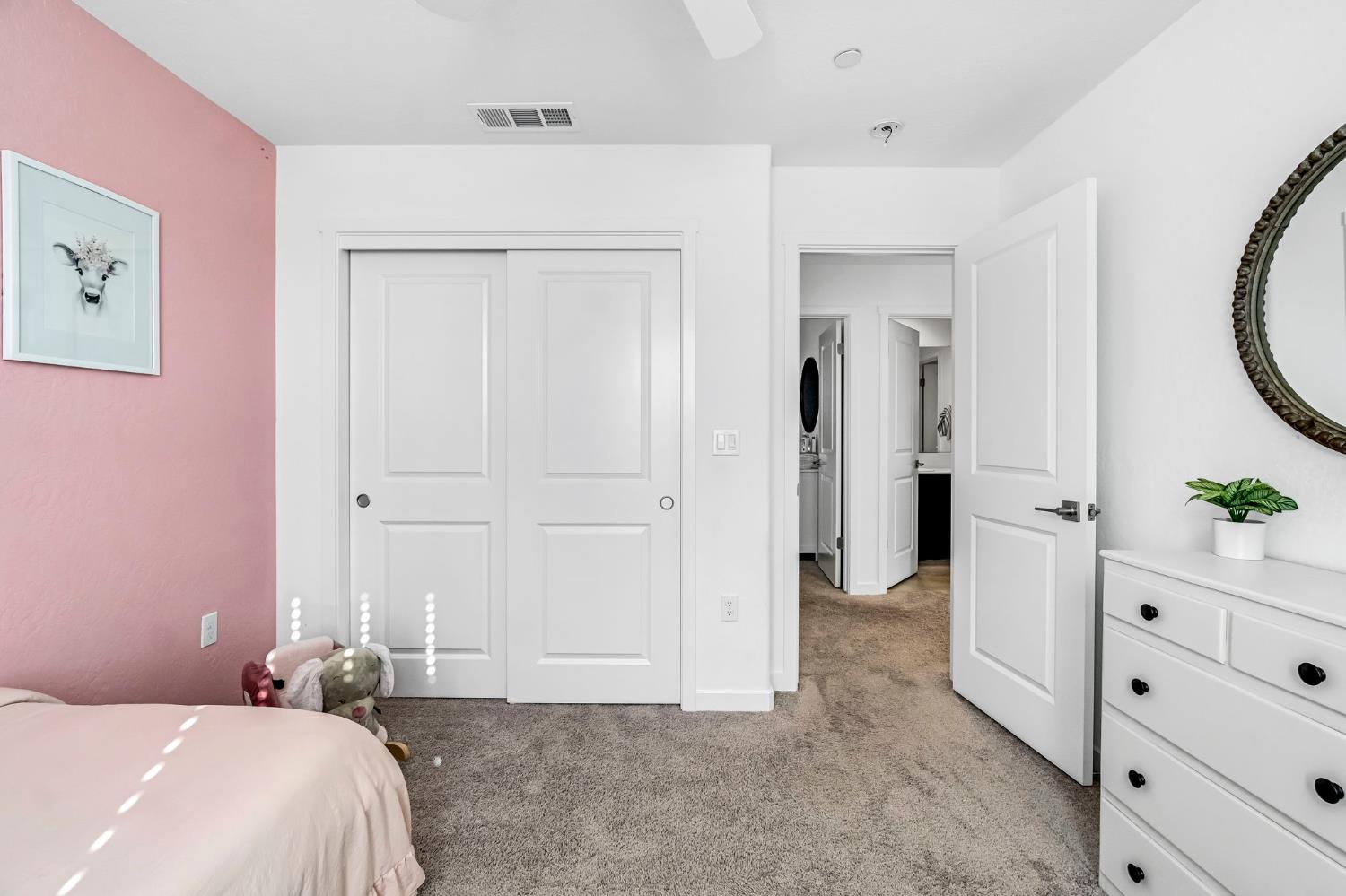 367 Talus Way South Madera, CA 93636 - Photo 21 of 40 a bedroom with a bed and a mirror on dresser