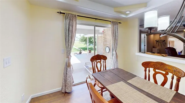 a view of a room that has a table and a chair in it