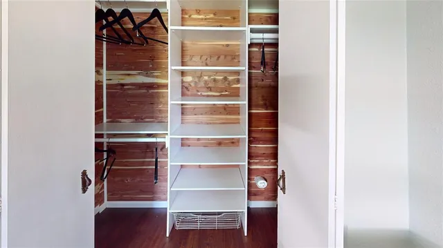 a view of walk in closet with empty racks