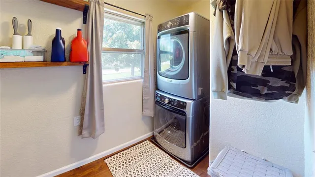 a close view of walk in closet with clothes and shoes