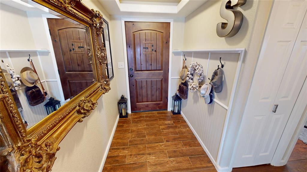 202 River Oaks Road Early, TX 76802 - Photo 2 of 37 a view of a hallway with wooden floor and stairs