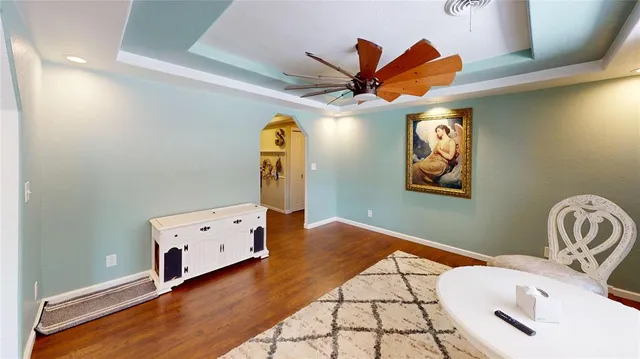 a view of a room with wooden floor and windows