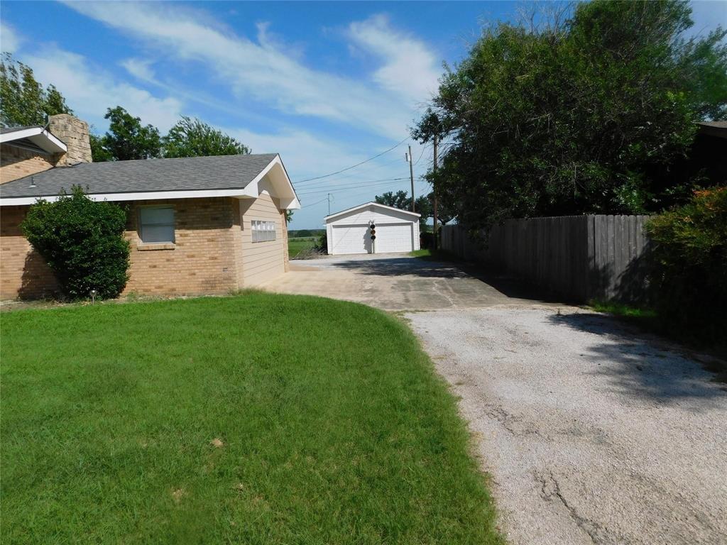 202 River Oaks Road Early, TX 76802 - Photo 32 of 37 a front view of a house with a yard and garage