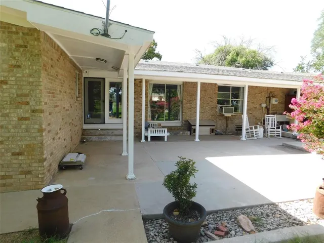 a lobby with furniture and potted plants