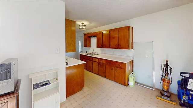 a kitchen with stainless steel appliances granite countertop a stove and a refrigerator
