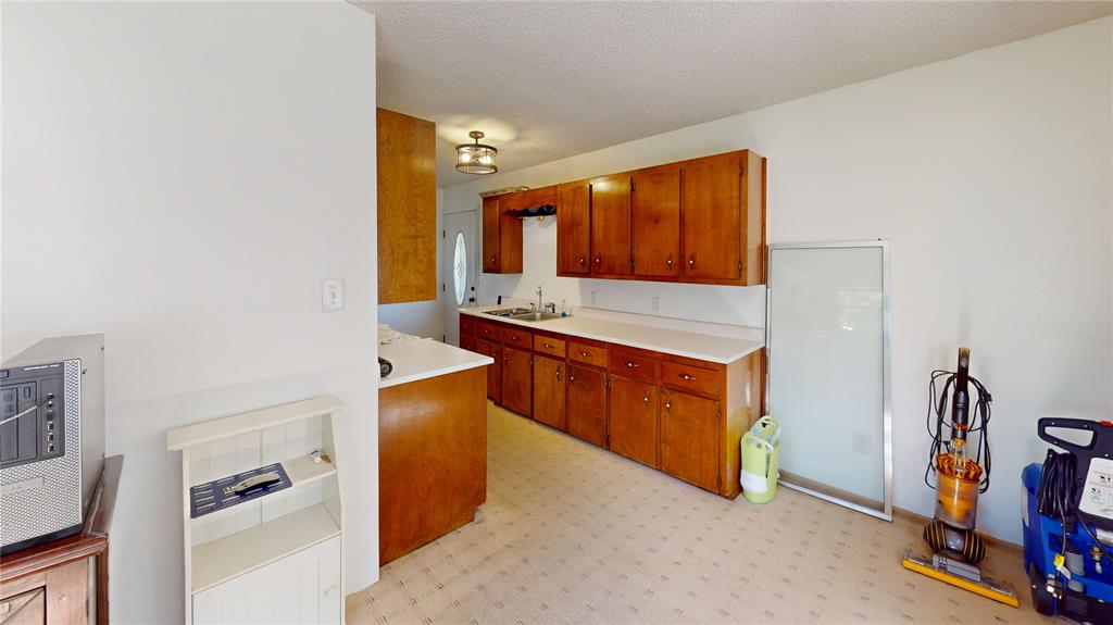 202 River Oaks Road Early, TX 76802 - Photo 9 of 37 a kitchen with stainless steel appliances granite countertop a stove and a refrigerator