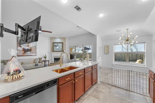 a kitchen with a sink appliances and cabinets