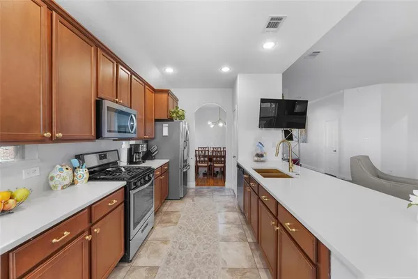 a kitchen with a sink stove and cabinets