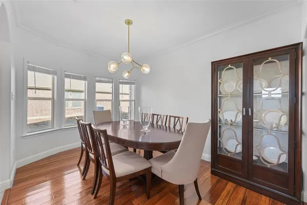 a view of a dining room with furniture wooden floor and chandelier