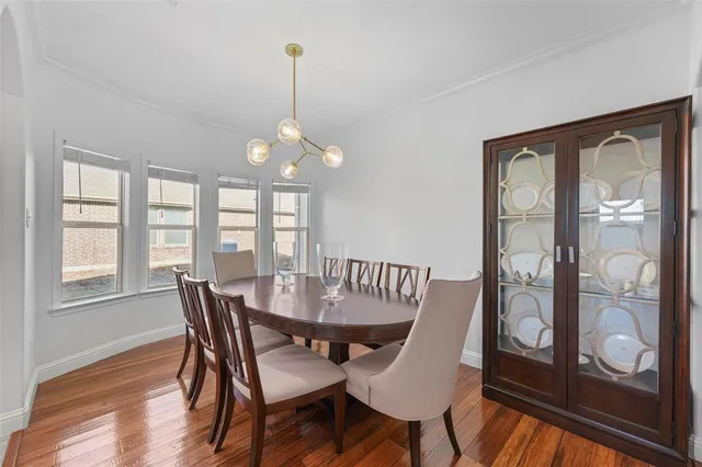 a view of a dining room with furniture wooden floor and chandelier