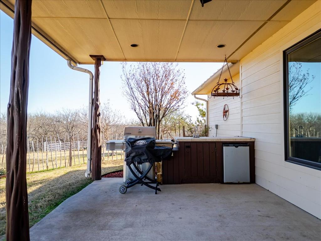 11918 Riek Road Krum, TX 76249 - Photo 30 of 40 a backyard of a house with table and chairs