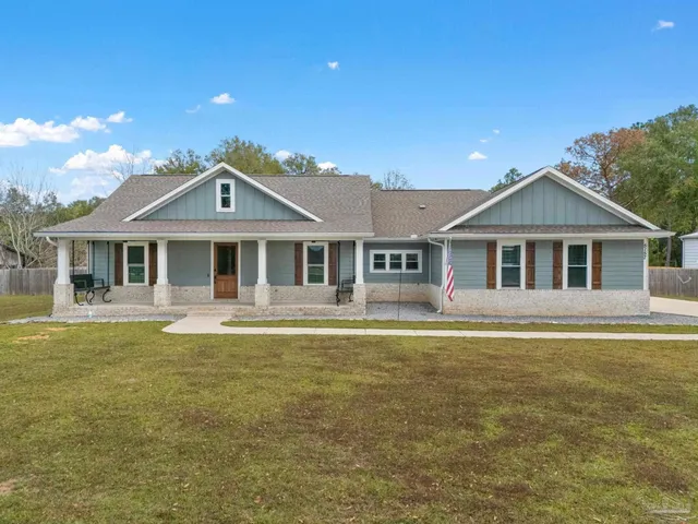a front view of a house with a yard table and chairs