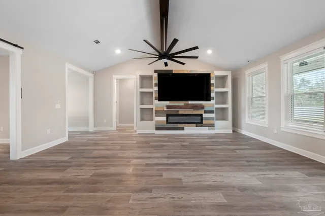 a kitchen with granite countertop a sink stainless steel appliances and cabinets
