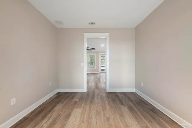 a bathroom with a granite countertop sink a toilet and a mirror