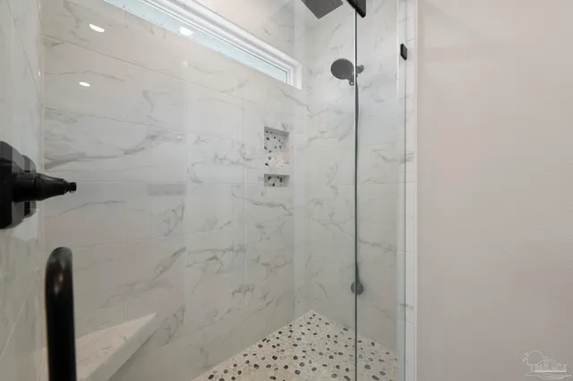 a view of a room with wooden floor and a ceiling fan