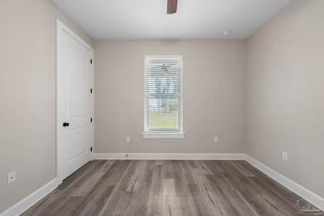 a view of a tennis court with trees in the background