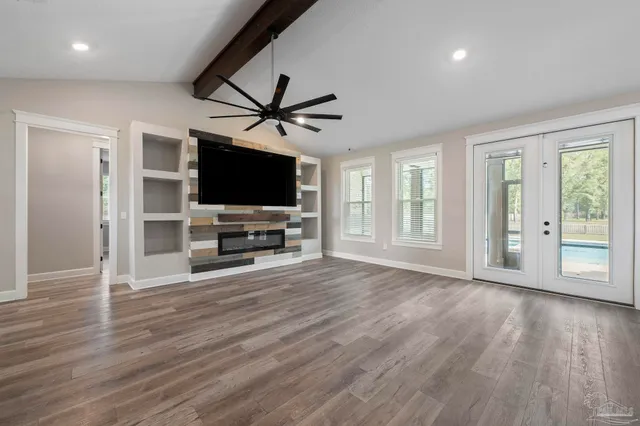a view of a room with wooden floor chandeliers and window