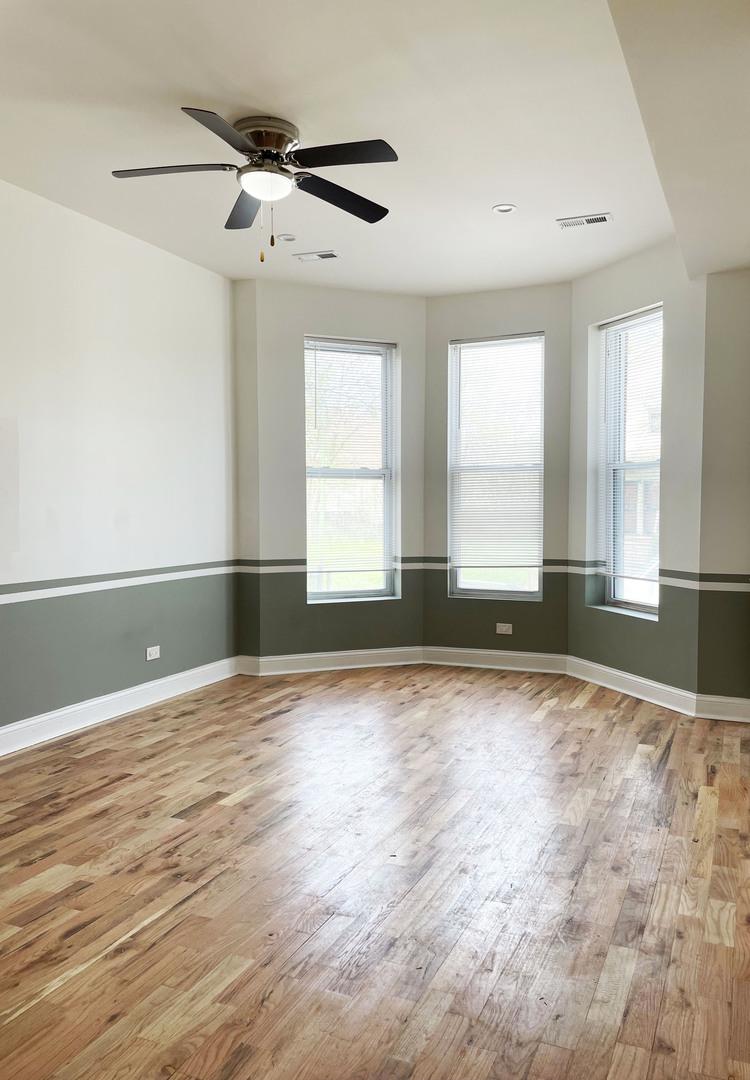 523 West 65th Place Chicago, IL 60621 - Photo 17 of 19 a view of an empty room with a window and wooden floor