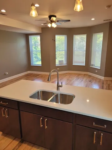 a view of a kitchen with a sink and chandelier