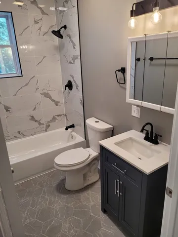 a bathroom with a double vanity sink toilet and shower