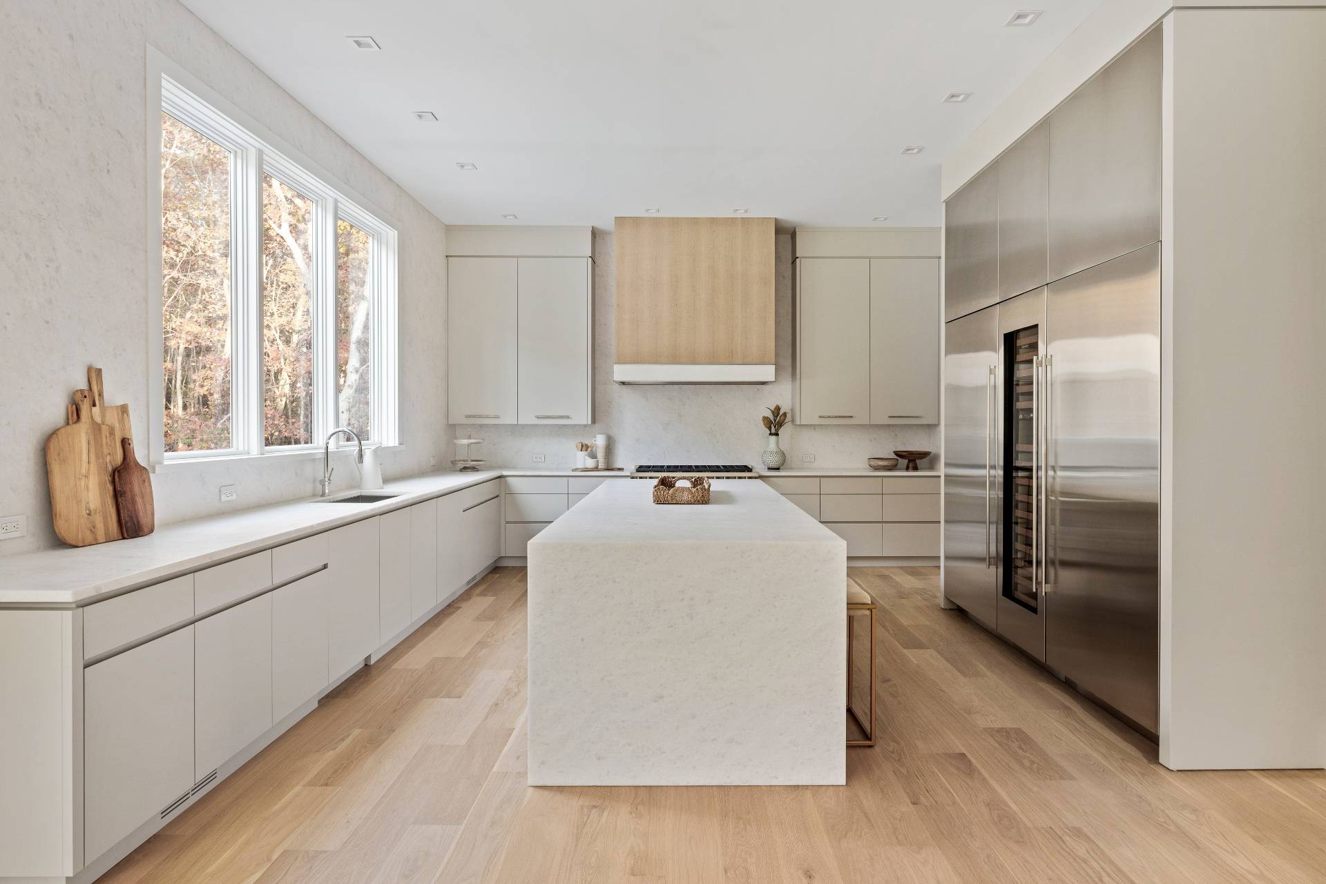 2069 Deerfield Road Sag Harbor, NY 11963 - Photo 13 of 37 a large white room with a large window and stainless steel appliances