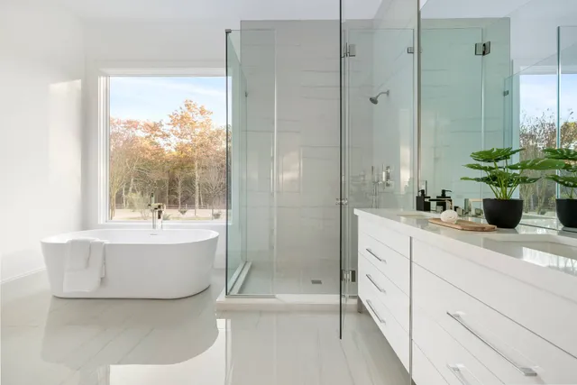 a bathroom with a tub sink and mirror