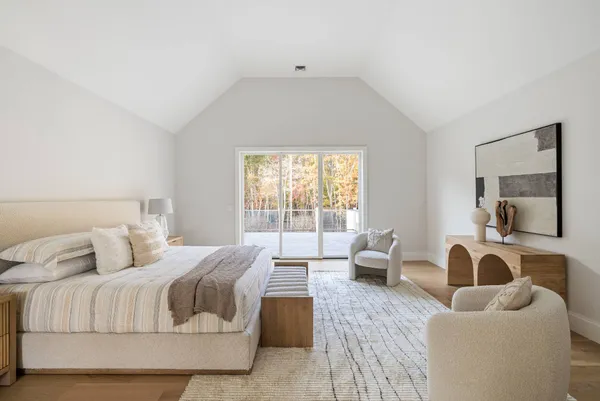 a bedroom with furniture and a large window