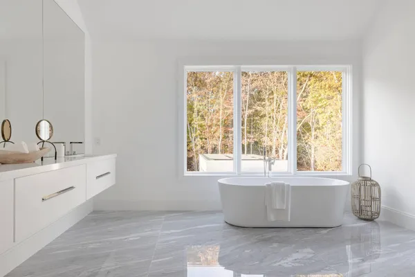 a bathroom with a tub sink and window