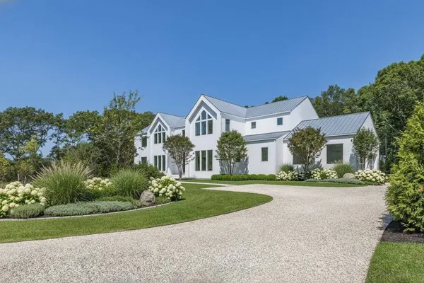 a front view of house with yard and green space