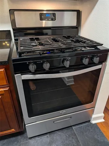a stove top oven sitting inside of a kitchen