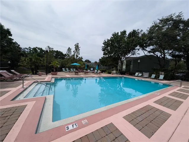 a view of a park with slide and a bench