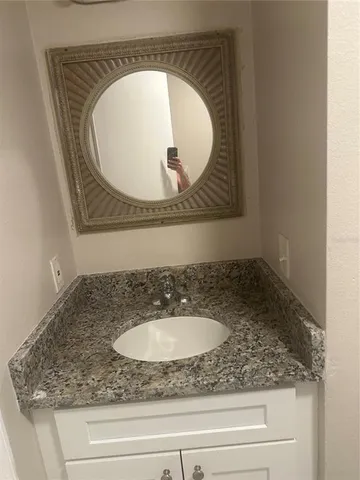 a bathroom with a sink and mirror