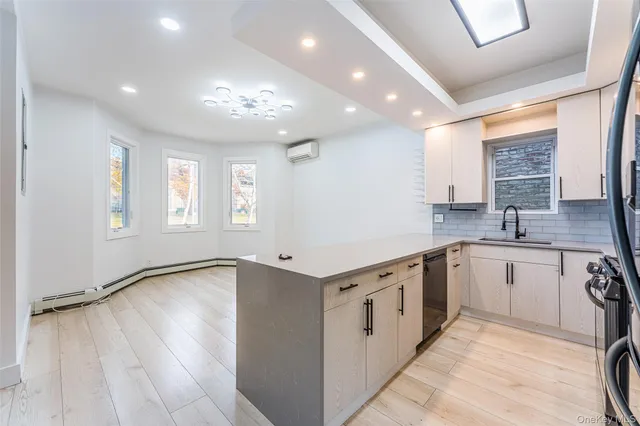 a kitchen with granite countertop a stove sink and cabinets