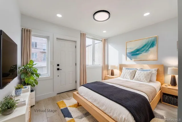 a bedroom with a large bed and a potted plant