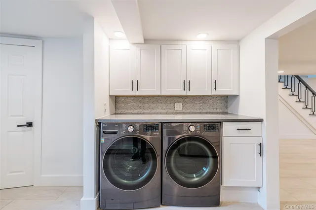 a utility room with sink dryer and washer