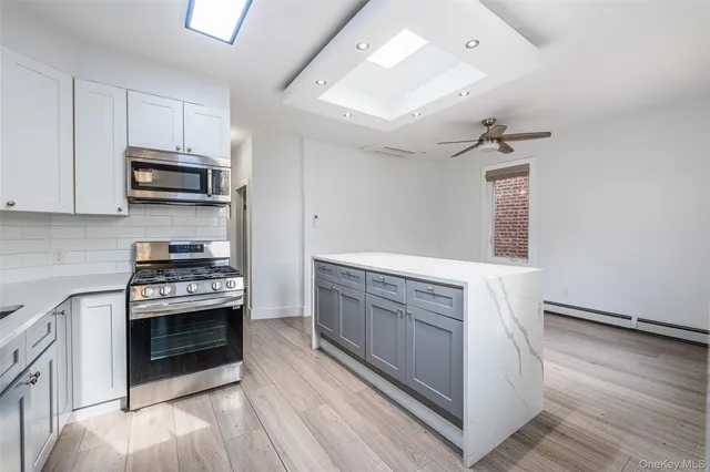 a kitchen with stainless steel appliances granite countertop a stove and a sink