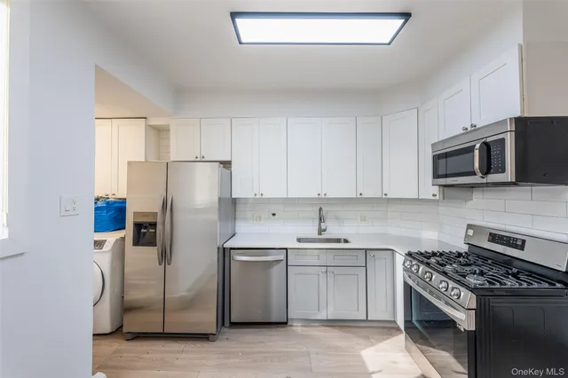a kitchen with appliances a sink and a counter top space