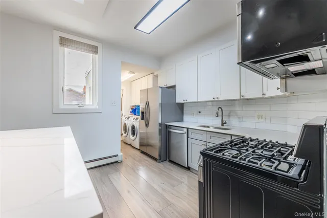 a kitchen with a stove a sink and a refrigerator