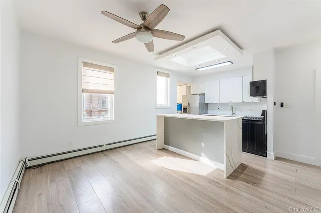a view of kitchen with cabinets and wooden floor