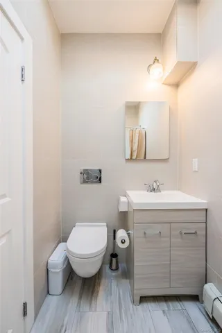 a bathroom with a toilet a sink and mirror