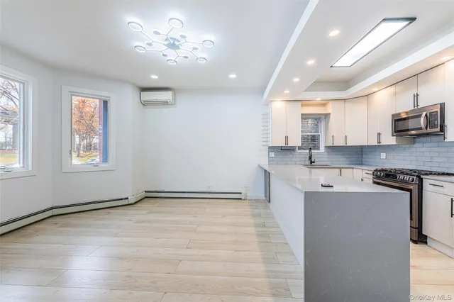 a view of a kitchen with a sink cabinets and stainless steel appliances