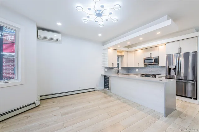 a kitchen with stainless steel appliances granite countertop a refrigerator a sink dishwasher a stove with white cabinets