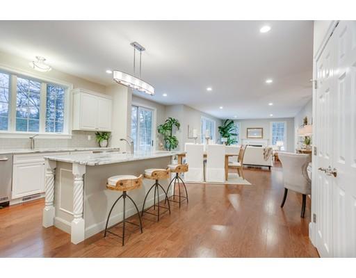 28 Hickory Hill Road Wayland, MA 01778 - Photo 13 of 30 a kitchen with stainless steel appliances granite countertop a refrigerator a sink dishwasher a dining table and chairs with wooden floor