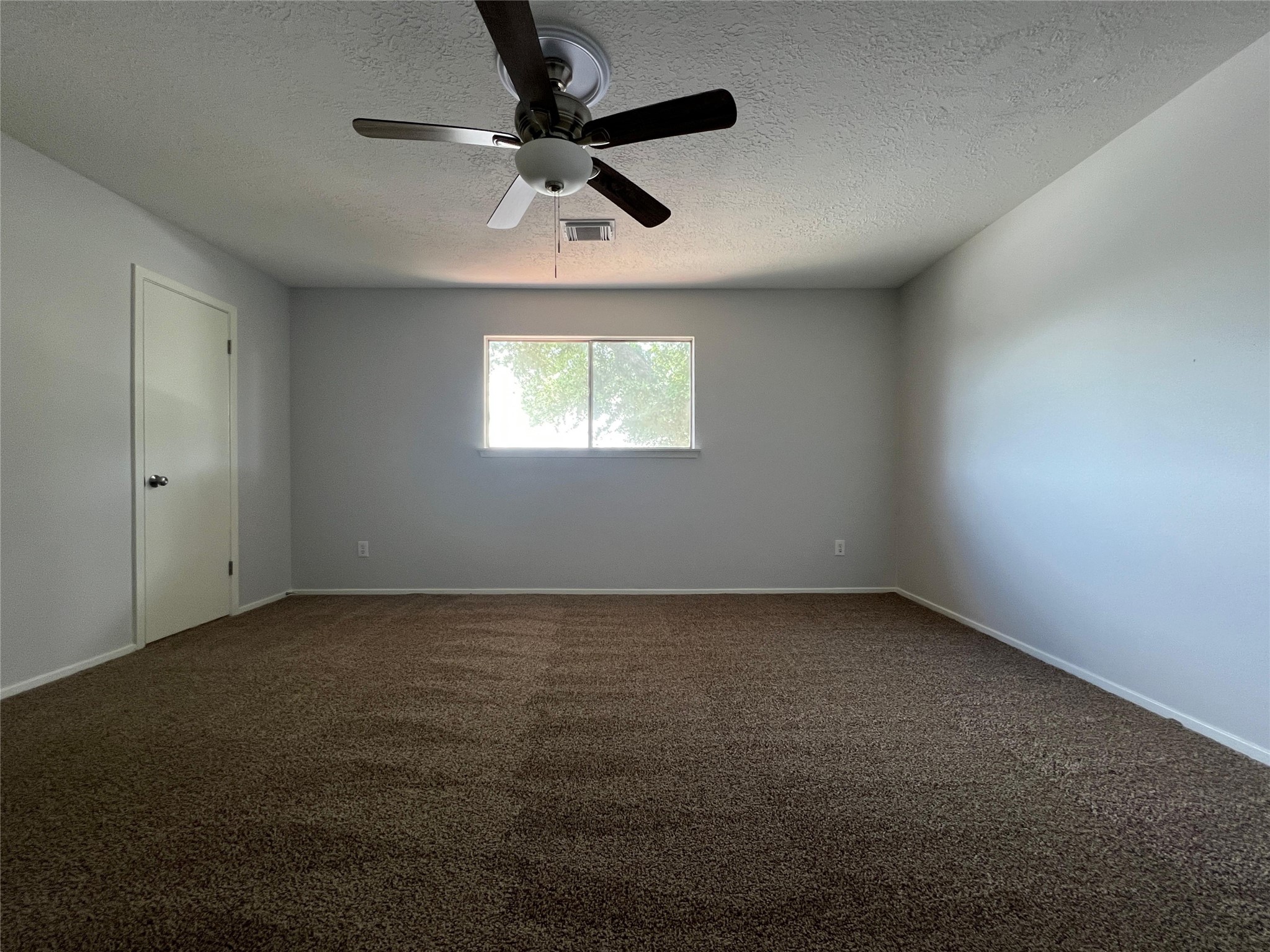 7012 Jetty Lane Houston, TX 77072 - Photo 13 of 24 an empty room with a window and a fan