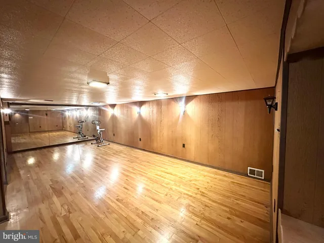 a view of a room with wooden floor