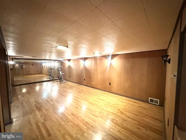 a view of a room with wooden floor