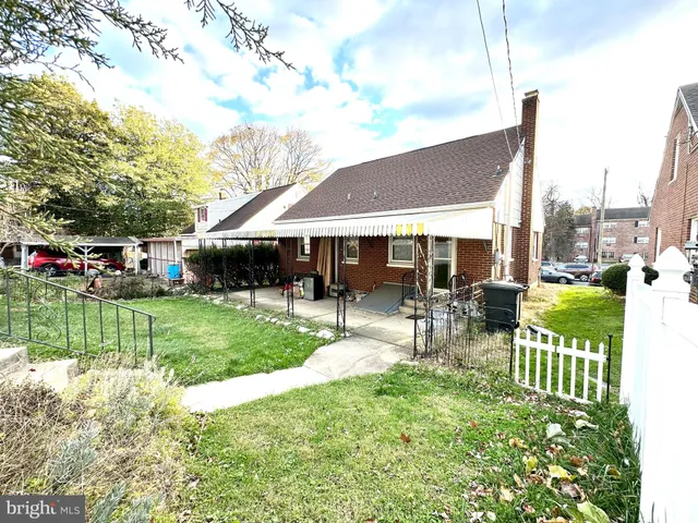 a view of a house with a yard patio and a garden